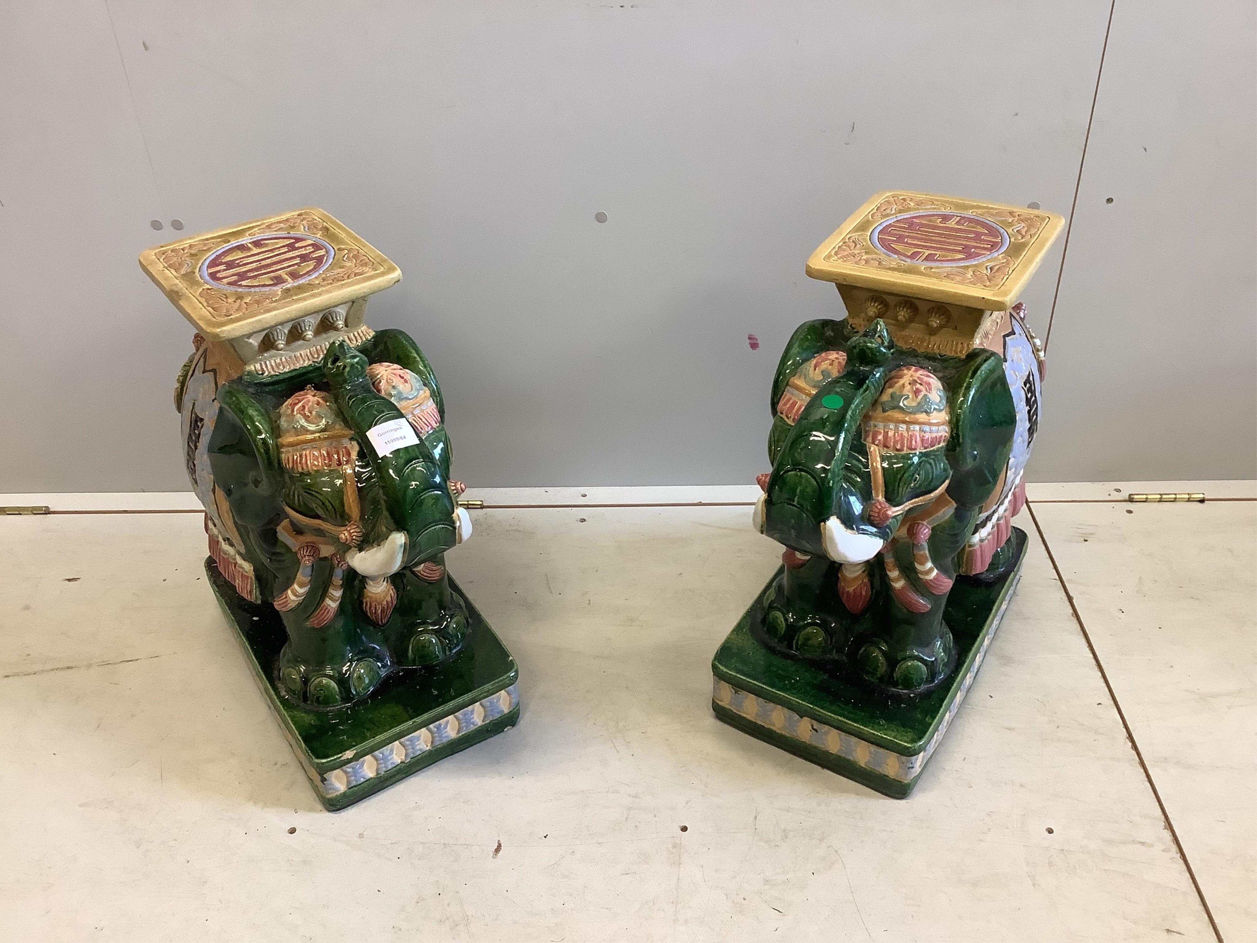 A pair of Chinese glazed earthenware elephant and howdah jardiniere stands, width 26cm, depth 44cm, height 56cm. Condition - fair